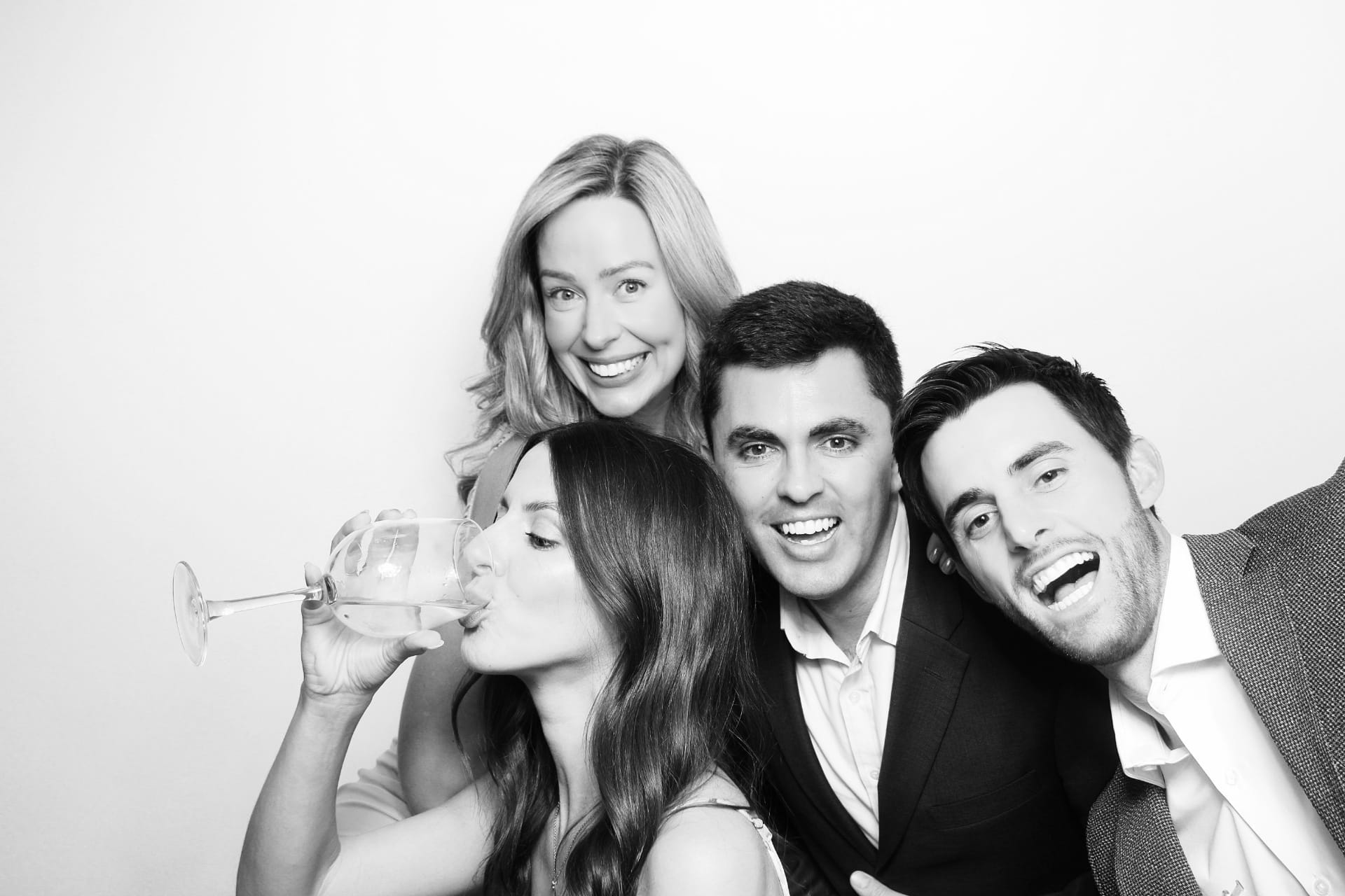 Black and white candid of four friends laughing